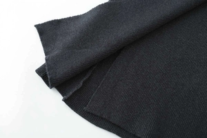 Detailed close-up showing fine knit texture and neat edge of black long skirt fabric