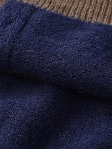 Macro view of dark blue fuzzy wool texture with brown ribbed knit hem detail