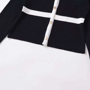 Classic black knit cardigan with white contrast stripes and gold round metal buttons