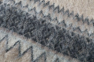Close-up of thick chevron knit fabric with brushed mohair texture in beige and grey