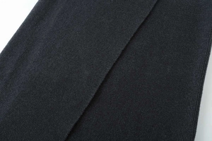 Close-up of high-quality dark grey ribbed knit fabric showing fine texture and pattern