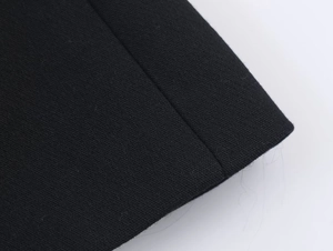Close-up detail of black blazer fabric texture with precise longitudinal stitching line