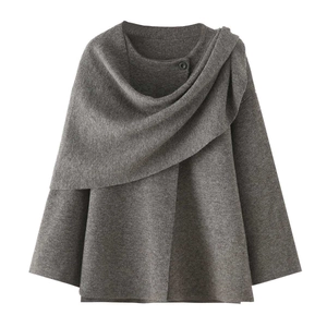 Women's asymmetrical grey knit poncho sweater with button closure and relaxed wrap design