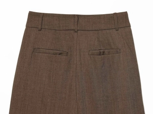 Detail of wool blend trousers featuring waist belt loops and a back welt pocket design
