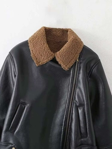 Detail of faux leather biker jacket with brown faux fur collar and metal zipper