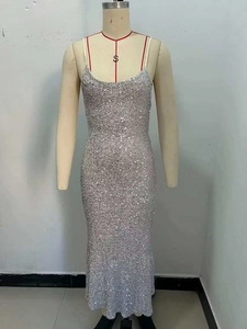 Close-up of sparkling silver sequins and delicate thin straps on a bodycon maxi dress