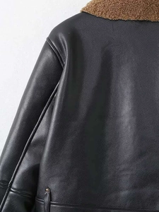Detail view of black faux leather biker jacket with brown faux shearling collar stitching