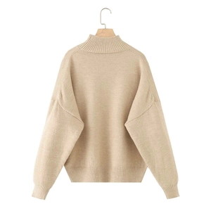 Detail showing oatmeal ribbed turtle neck, drop shoulder and knit cuffs on winter sweater