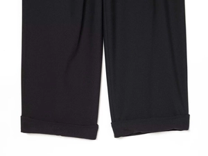 Detailed view of the fixed cuffed hem and high-quality black woven fabric texture