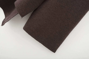 Detailed close-up showing the premium thick knit texture of the dark brown poncho sweater