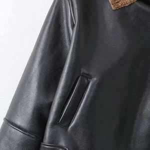 Women's black leather biker jacket featuring brown faux shearling trim and pocket details