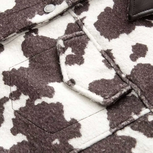 Chic black and white cow print plush jacket with leather collar and metal snap button