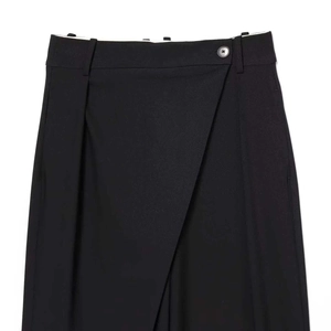 Black high-waist wide-leg trousers featuring asymmetrical cross waist with a single button