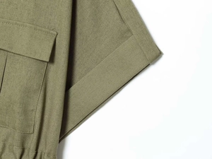 Close-up of olive green cargo pocket with premium stitching on woven fabric