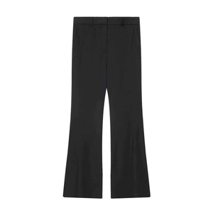 Detail of black wide-leg suit trousers showing belt loops and high-quality fabric texture