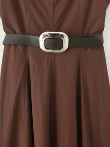 Detail of caramel brown A-line dress featuring a black leather belt and silver metal buckle