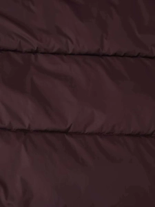 Macro detail of wine red quilted puffer coat showing textured fabric and stitching