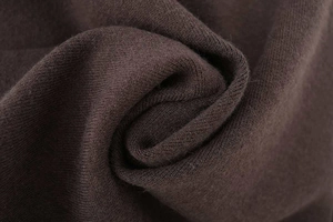 Close-up of deep coffee brown knit fabric showing soft texture and fine fiber details