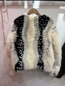 Detail of striped faux fur jacket in black, white and grey with soft fluffy texture