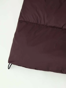 Close-up of quilted plum puffer coat hem with adjustable drawstring and toggle detail