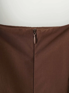Close-up of caramel brown fabric with hidden zipper and fine plain weave texture