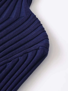 Detailed macro shot of navy blue ribbed knit fabric texture and high-quality seam stitching