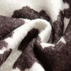Close-up of thick cow print faux fur texture on a stylish autumn jacket for women
