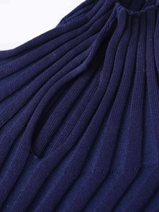 Macro shot of navy blue ribbed knit fabric showing high collar detail and texture