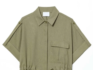 Detail of olive green utility shirt with epaulets, flap pocket, and drawstring waist