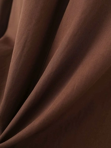 Close-up of caramel brown twill fabric texture for women's vintage A-line dress