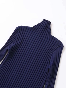 Detailed view of the navy blue ribbed knit texture and turtleneck design on a slim fit sweater