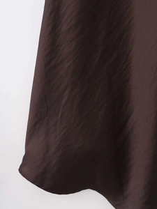 Detailed macro texture of smooth dark brown satin fabric with elegant silk-like luster