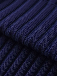Detailed macro view showing navy blue ribbed knit fabric texture and vertical weave pattern
