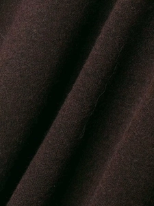 Close-up of thick dark brown wool knit fabric with soft texture and elegant drape