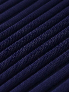 Close-up of the navy blue rib-knit fabric texture on this minimalist autumn sweater