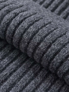 Macro detail of dark grey ribbed knit fabric showing soft texture and premium elasticity
