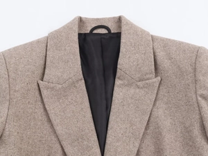 Detail of herringbone wool blazer showing lapels, lining, and inner neck hook
