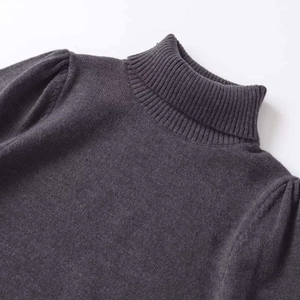 Elegant dark grey turtleneck knit sweater with puff sleeves and ribbed texture detailing