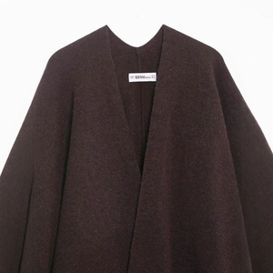 Women's dark brown textured tweed poncho knitwear featuring a stylish fringe detail
