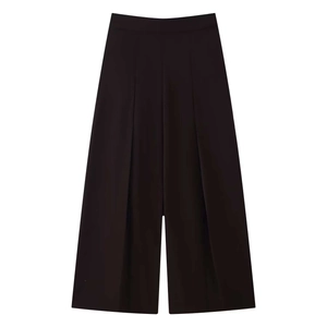 Detail of high-waist black wide-leg trousers featuring elegant pleated front design