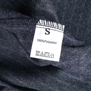 Close-up of washing label showing 100% polyester material on navy pinstripe coat
