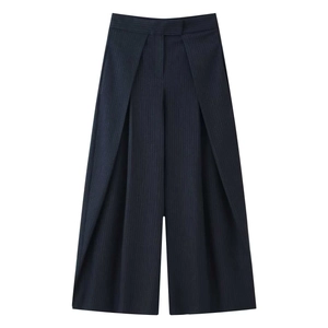 Detail of high-waist navy pinstripe wide-leg trousers with overlapping pleated design