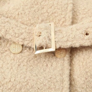 Long beige teddy fleece coat featuring a stylish waist belt and premium gold hardware