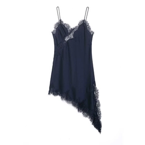 Detail of navy silk slip dress with delicate black eyelash lace trim and irregular hemline
