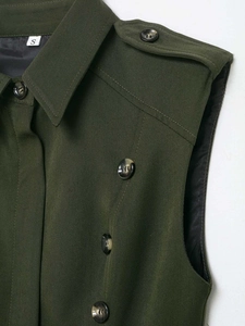 Close-up of military olive green sleeveless dress with lapels and marble buttons