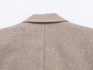 Detailed view of brown herringbone wool blazer collar with high-quality stitching