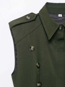 Close-up of olive green sleeveless dress showing shoulder epaulettes and button details