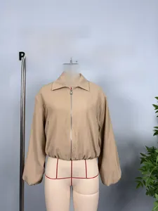 Detail view of khaki short jacket featuring a metal zipper and stylish lantern sleeves