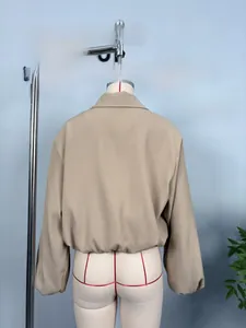 Back view of a khaki cropped jacket featuring drop shoulders and elasticated hem details