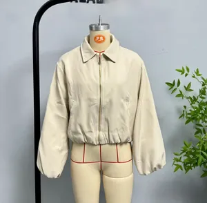 Detail of beige cropped zip-up jacket with elastic hem and oversized collar on mannequin